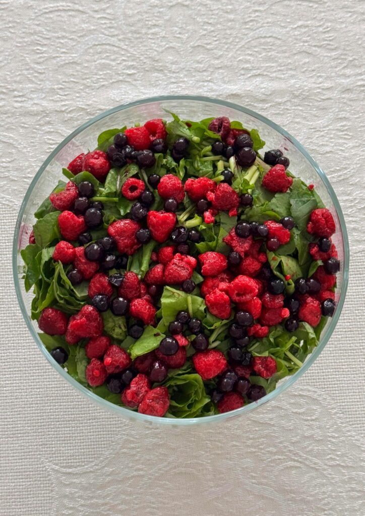 The Best Raspberry Spinach Salad A healthy and colorful spinach salad topped with fresh raspberries and blueberries.